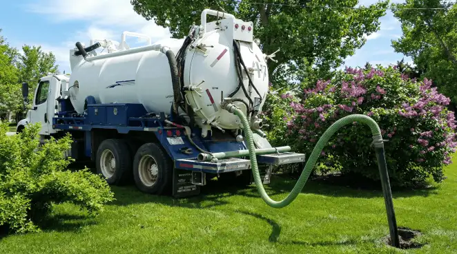 Professional vacuum truck performing residential drainage and septic maintenance in Anchorage, AK